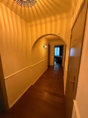 an empty hallway with a ceiling with a chandelier at Charmehotel Klokkenhof in Brasschaat