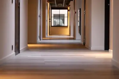 an empty corridor in a building with a yellow door at Bremberg Hotel in Haasrode