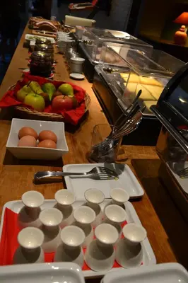 a table with a counter with eggs and fruit on it at Hotel De Franse Kroon in Diest