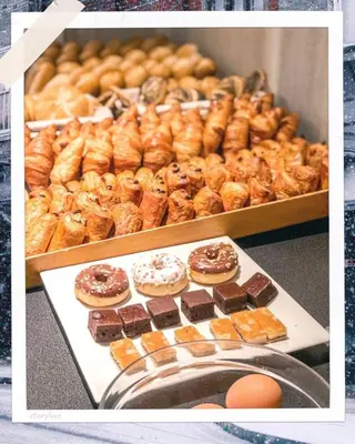 a bunch of different types of donuts on display at Hotel De Fierlant in Brussels