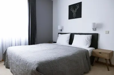 a bedroom with a bed with white sheets and white pillows at Hotel De Fierlant in Brussels