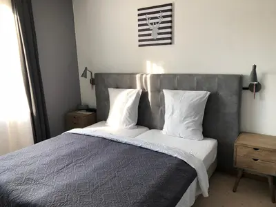 a bedroom with a large bed with white pillows at Hotel De Fierlant in Brussels