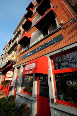 a store front of a building with a red door at Hotel Castel in Ghent