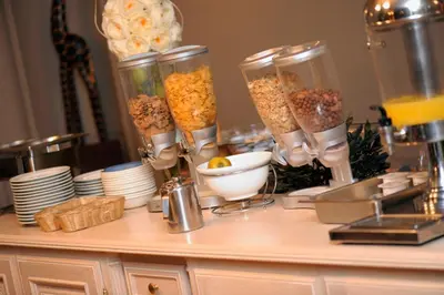 a counter with some food in containers on it at Hotel Castel in Ghent
