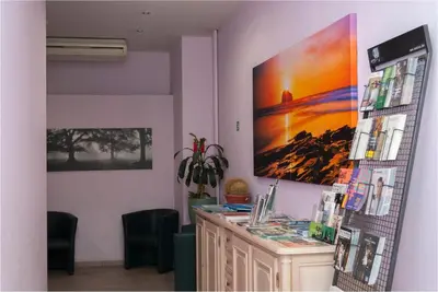 a room with a desk and a large painting on the wall at Hotel Castel in Ghent
