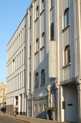 a building with a sign on the side of it at Hotel Adoma in Ghent