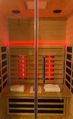 a shower with red lights in a room at Hotel Adoma in Ghent