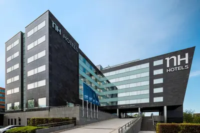 a large building with a nhm hotels sign on it at NH Brussels Airport in Diegem
