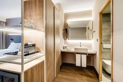 a small bathroom with a sink and a toilet at NH Brussels Airport in Diegem