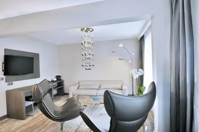 a living room with two chairs and a couch at Hotel Agenda Louise in Brussels