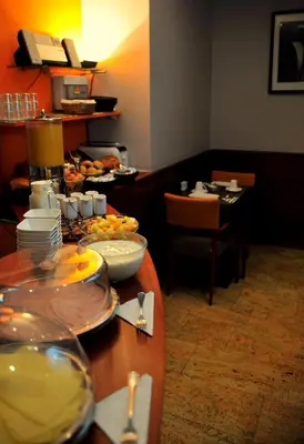a table with plates of food on top at Hotel Agenda Louise in Brussels