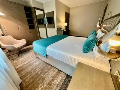 a hotel room with a bed and a chair at Hotel Agenda Louise in Brussels