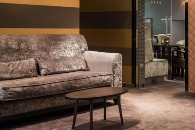 a living room with a couch and a coffee table at Keizershof Hotel Aalst in Aalst
