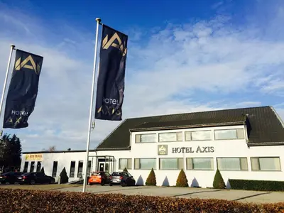 two flags are flying in front of a building at Axis Hotel in Kortenberg