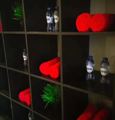 a shelf filled with red balls and bottles with skulls at Axis Hotel in Kortenberg