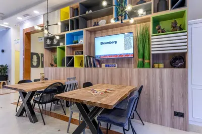 a dining room with two tables and chairs at Holiday Inn Brussels Schuman by IHG in Brussels
