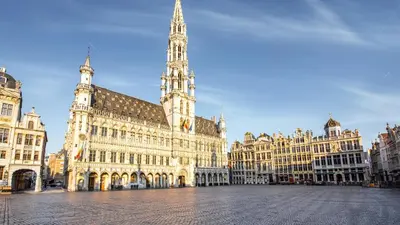 a large building with a clock tower in a city at Holiday Inn Brussels Schuman by IHG in Brussels