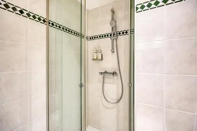 a shower with a glass door in a bathroom at Holiday Inn Brussels Schuman by IHG in Brussels