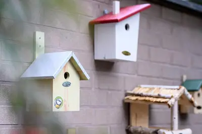 a couple of birdhouses on the side of a building at Holiday Inn Brussels Schuman by IHG in Brussels