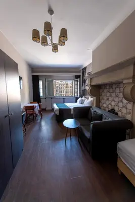 a living room with a couch and a table at Résidence-Hotel Le Quinze Grand Place Brussels in Brussels