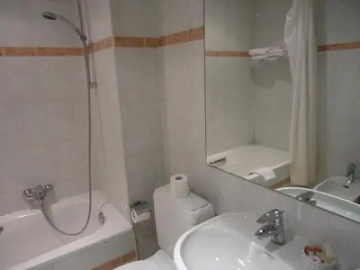 a bathroom with a toilet and a sink and a mirror at Résidence-Hotel Le Quinze Grand Place Brussels in Brussels