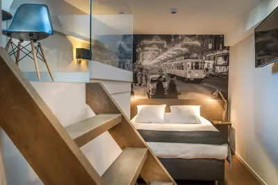 a hotel room with a bed and a picture of a train at Résidence-Hotel Le Quinze Grand Place Brussels in Brussels