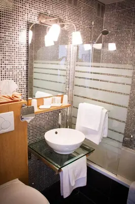 a bathroom with a sink and a shower at Hotel Carlton in Ghent