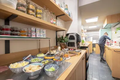 a kitchen with a counter with bowls of food at Hotel Carlton in Ghent