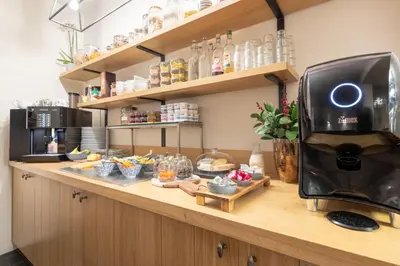 a kitchen counter with a coffee machine on it at Hotel Carlton in Ghent