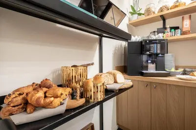a shelf with bread and pastries on it in a kitchen at Hotel Carlton in Ghent