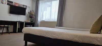 a hotel room with a bed and a television at Hotel Floris Arlequin Grand-Place in Brussels