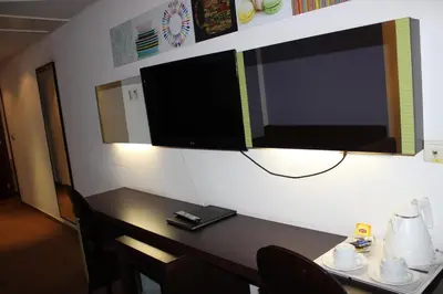 a room with a table and a television on a wall at Hotel Floris Arlequin Grand-Place in Brussels