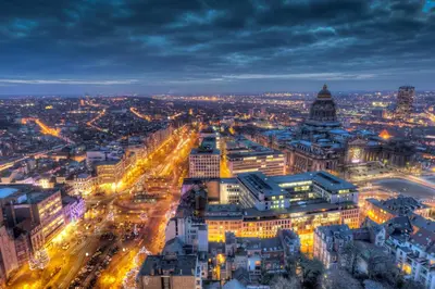 an aerial view of a city at night at The Hotel Brussels in Brussels