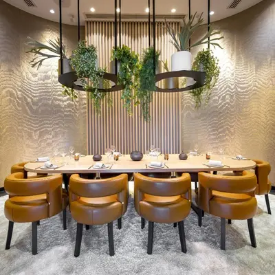 a dining room with a table and chairs at The Hotel Brussels in Brussels