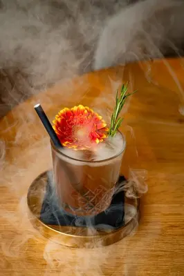 a drink with a flower in a cup on a table at The Hotel Brussels in Brussels