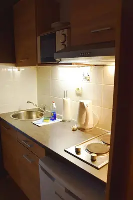 a kitchen with a sink and a counter top at Condo Gardens Antwerp in Antwerp