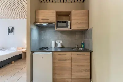 a small kitchen with a sink and a microwave at Condo Gardens Brussels in Brussels