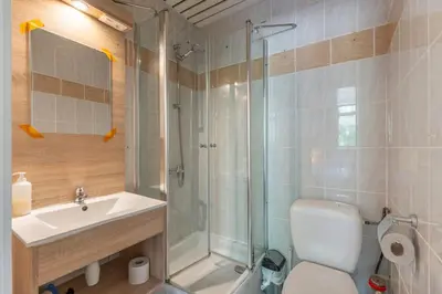 a bathroom with a shower and a toilet and a sink at Condo Gardens Brussels in Brussels