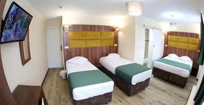 a small room with two beds in it at Sun Hotel in Brussels