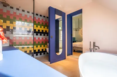 a bathroom with colorful tiles on the walls at P6 Antwerp in Antwerp