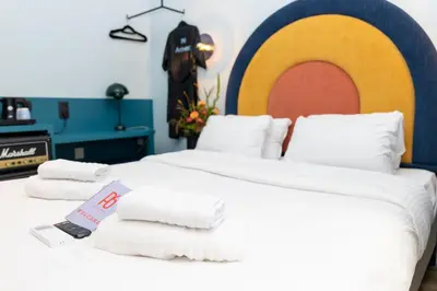 a bedroom with a large bed with towels on it at P6 Antwerp in Antwerp
