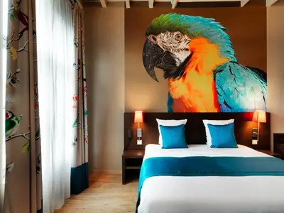 a painting of a parrot on the wall of a bedroom at Hotel Harmony in Ghent