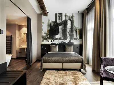 a bedroom with a bed and a bath room at Hotel Harmony in Ghent