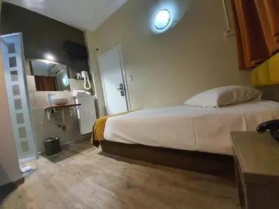 a bedroom with a large bed in a room at Hotel Midi-Zuid in Brussels