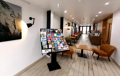 a waiting room at a vet clinic with chairs and tables at Hotel Midi-Zuid in Brussels