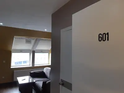 a living room with a couch and a window at Hotel Midi-Zuid in Brussels
