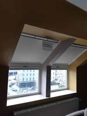a room with two windows in a building at Hotel Midi-Zuid in Brussels
