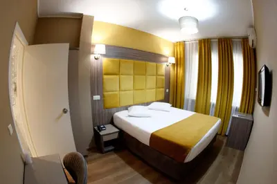 a hotel room with a bed and a television at Hotel Midi-Zuid in Brussels