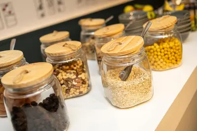 a group of glass jars filled with nuts and seeds at Hotel Louise in Brussels