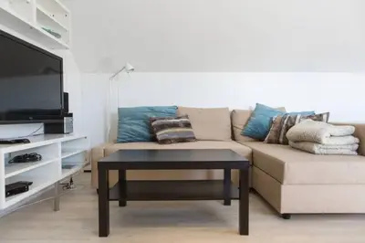 a living room with a couch and a coffee table at Studio Apartment Alba in La Hulpe